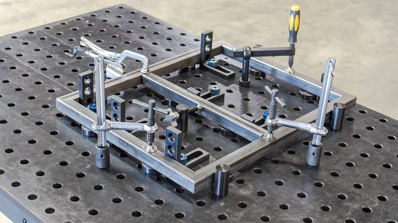 we demonstrate how to elevate, locate, stop, and clamp down stock for a basic square frame.